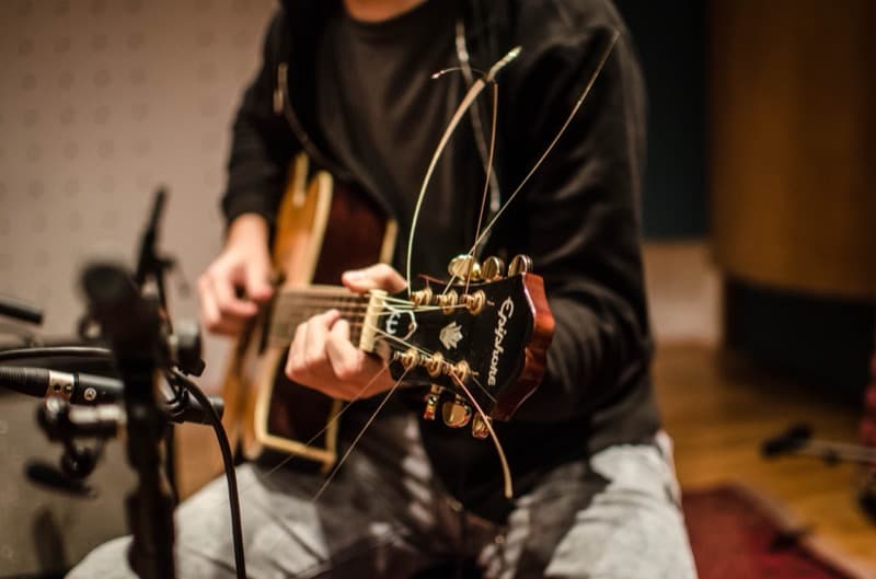 An acoustic guitar in a recording session