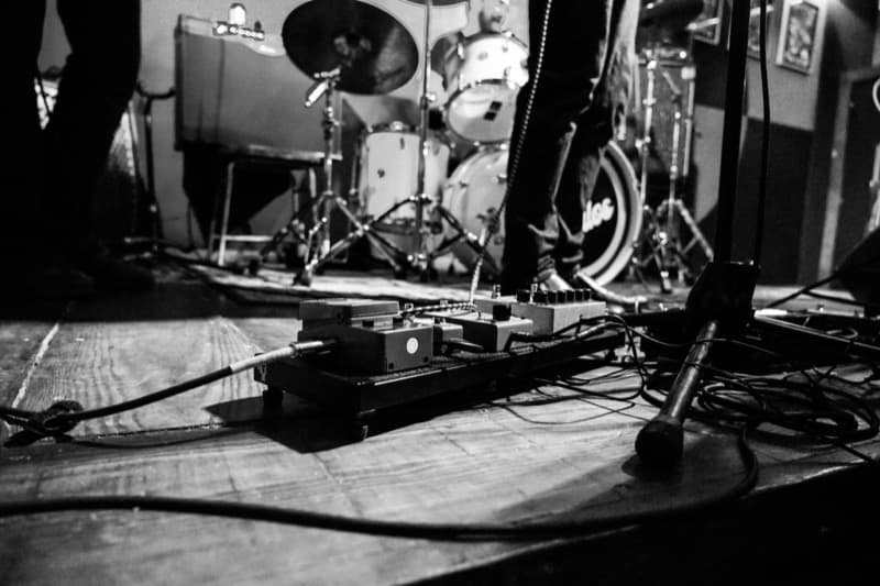A live music setup with drums and effects pedals