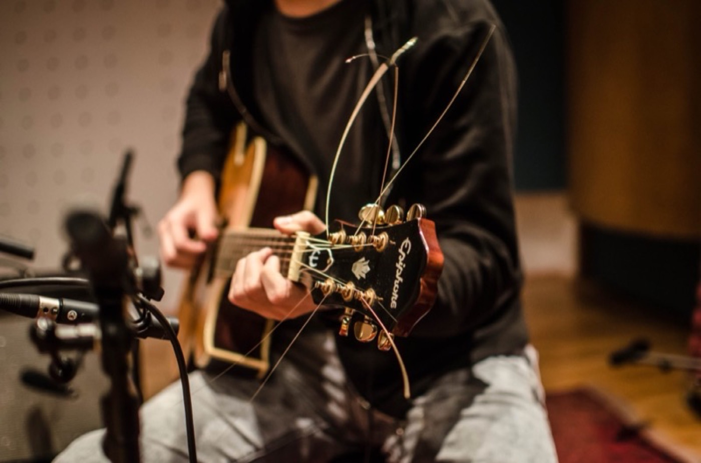 A guitarist recording in a studio